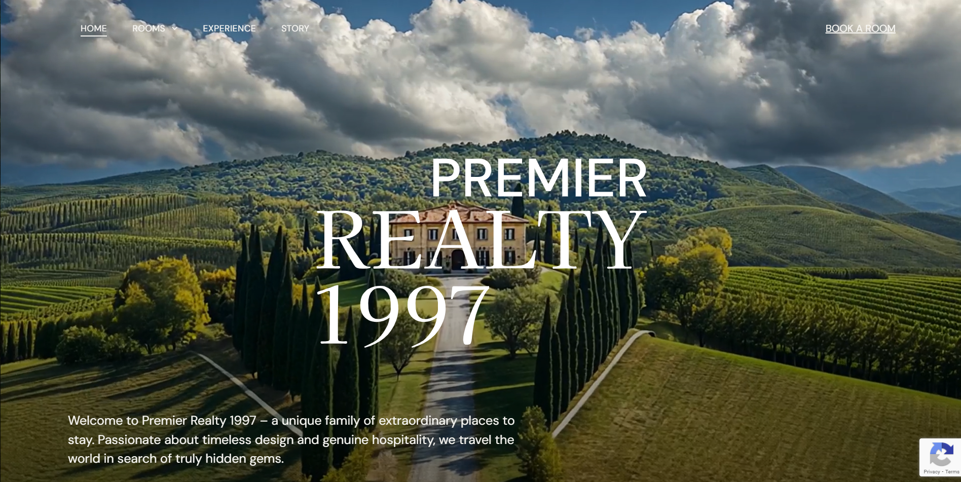 Premier Realty sign over a villa with a long driveway and surrounding vineyard.