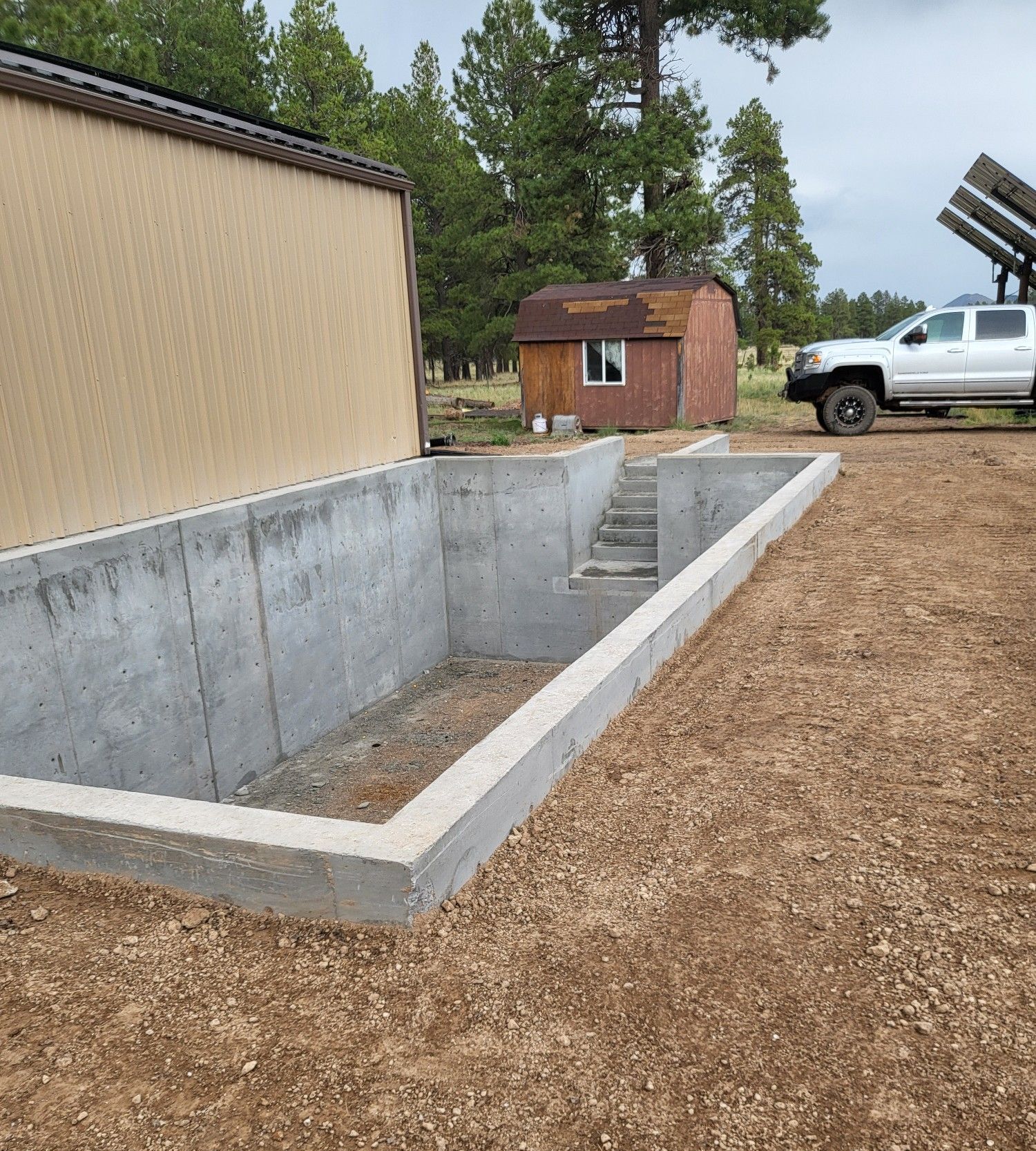 A group of construction workers are working on a construction site in front of a house.