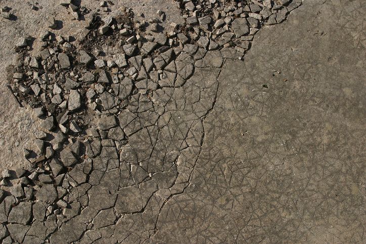 A close up of a cracked concrete surface