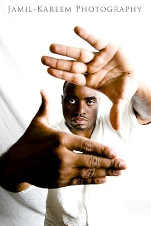 A man in a white shirt is making a frame with his hands