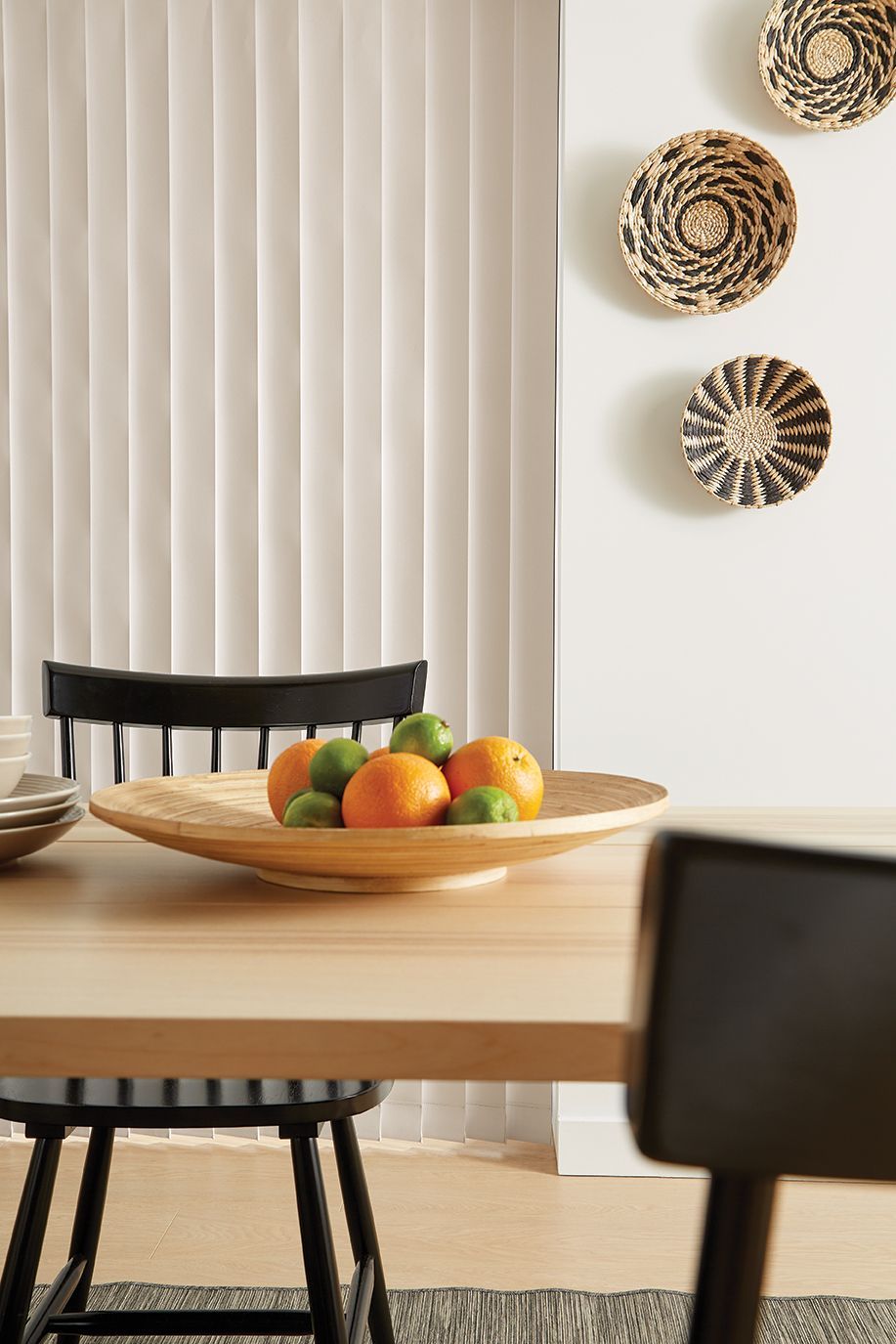 There is a bowl of fruit on the table in the dining room.