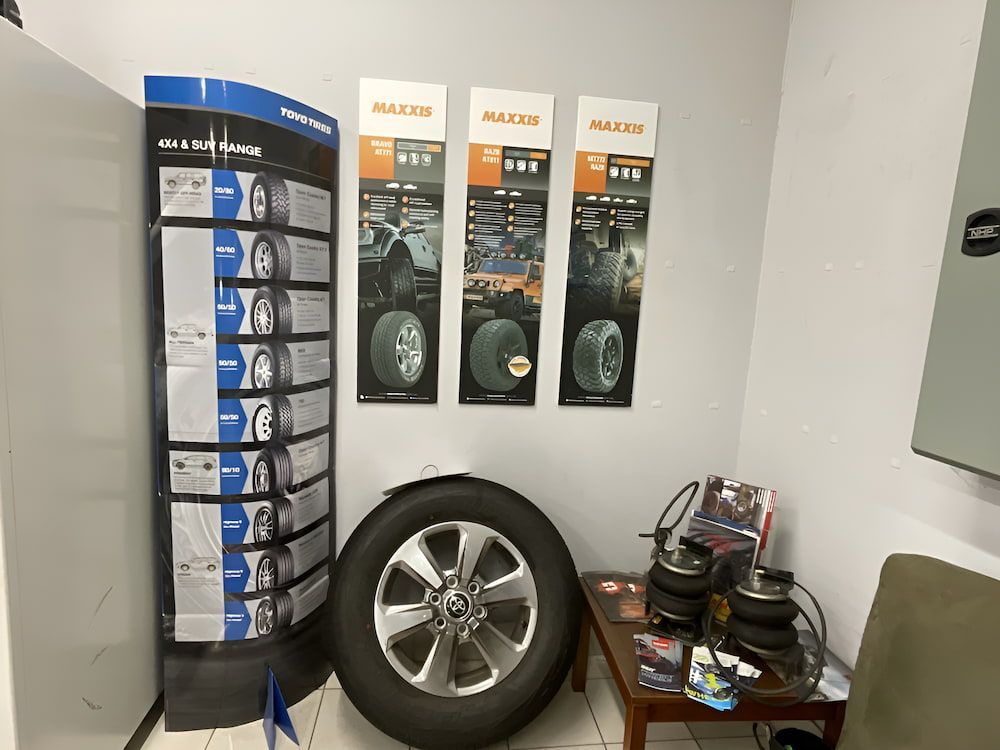 A Room With A Display Of Tires And Wheels On The Wall — Bones Tyres in Armidale, NSW