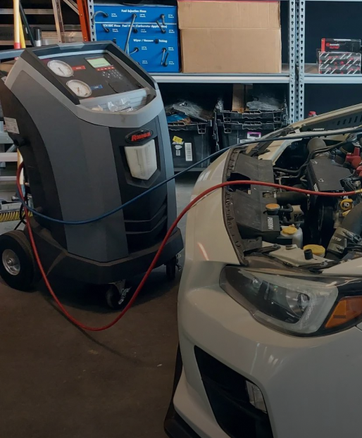A car is being serviced by a machine in a garage | VP Automotive