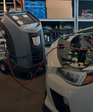 A car is being serviced by a machine in a garage | VP Automotive