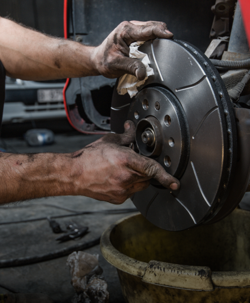 A person is working on a car engine | VP Automotive
