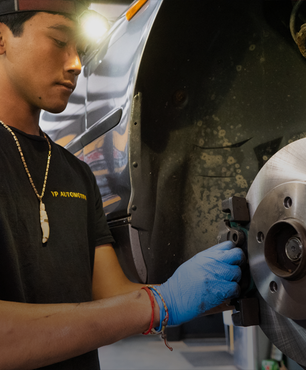 A person is working on a car engine | VP Automotive