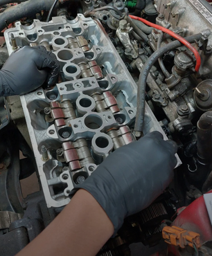 A person is working on a car engine | VP Automotive