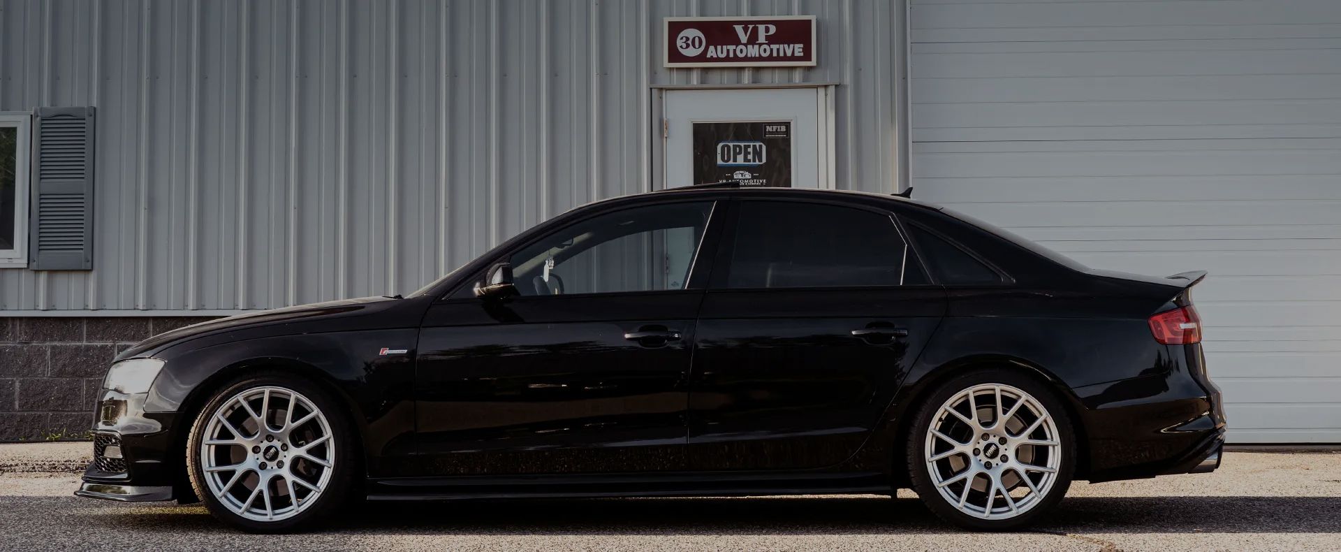 A black car parked in front of the shop | VP Automotive