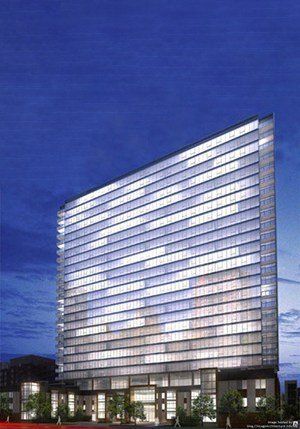 A large building with a lot of windows is lit up at night.