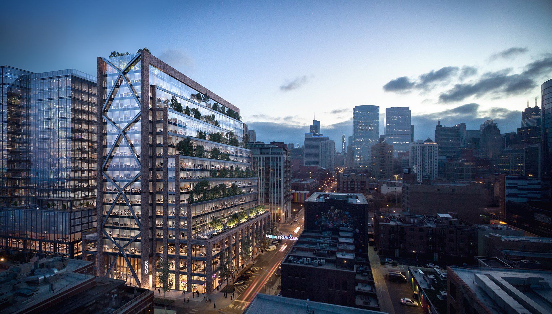 An aerial view of a city at night with a large building in the foreground.
