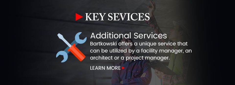 An advertisement for key services with a wrench and screwdriver