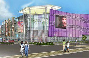 A group of people are walking in front of a large purple building.