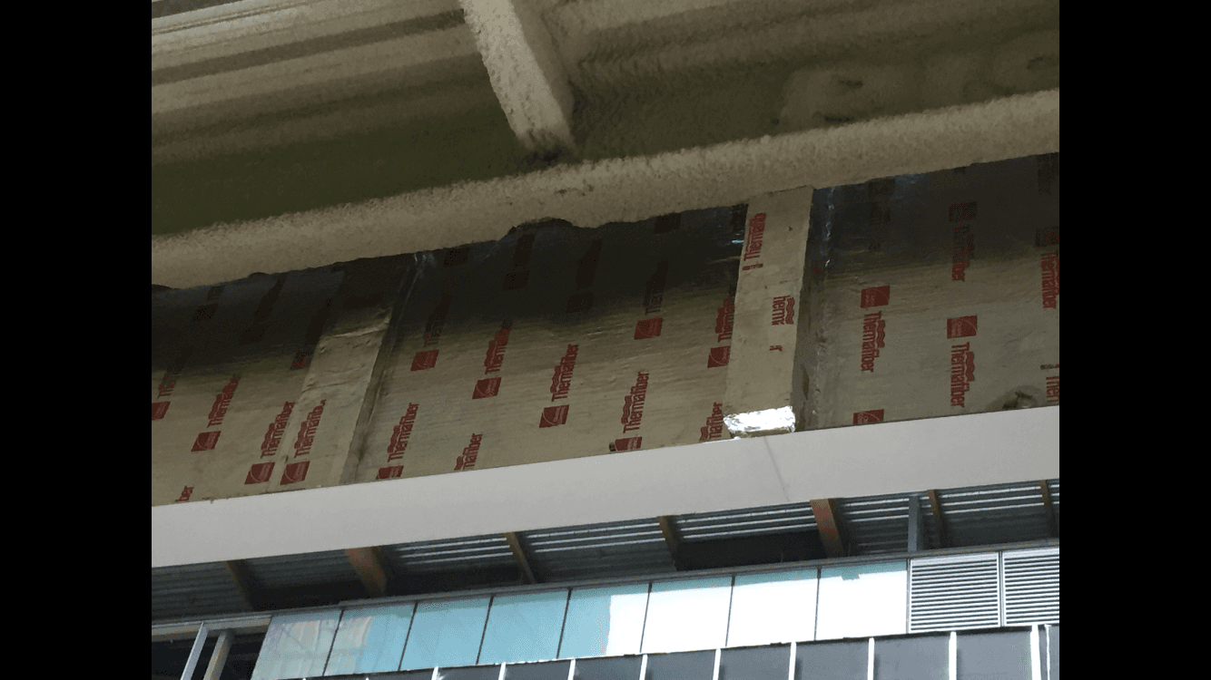 A building with a lot of ducts hanging from the ceiling.