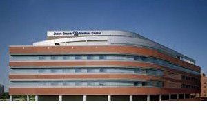 A large brick building with a lot of windows and a blue sky in the background.
