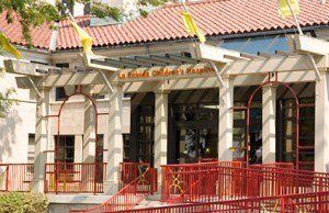 A building with a red fence and a sign that says la florida children 's hospital