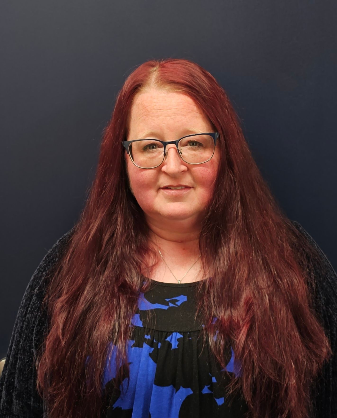 A large building with a lot of windows is lit up at night.