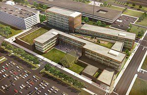An aerial view of a large building with a parking lot in front of it