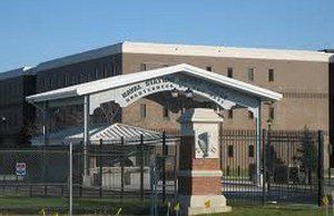 A large building with a white archway in front of it.