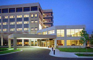 A large building with lots of windows is lit up at night