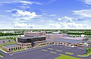 An aerial view of a large building with a parking lot in front of it.