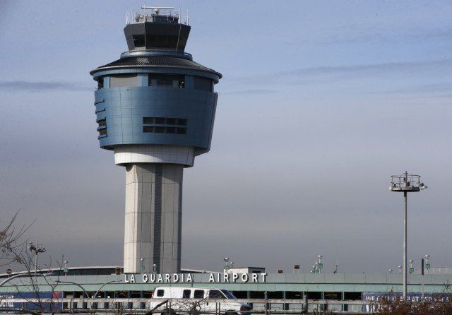 A large blue tower with the words la guardia airport on it
