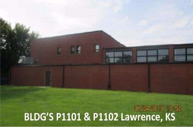 A large brick building with the words bldg 's p1101 & p1102 lawrence ks on the bottom