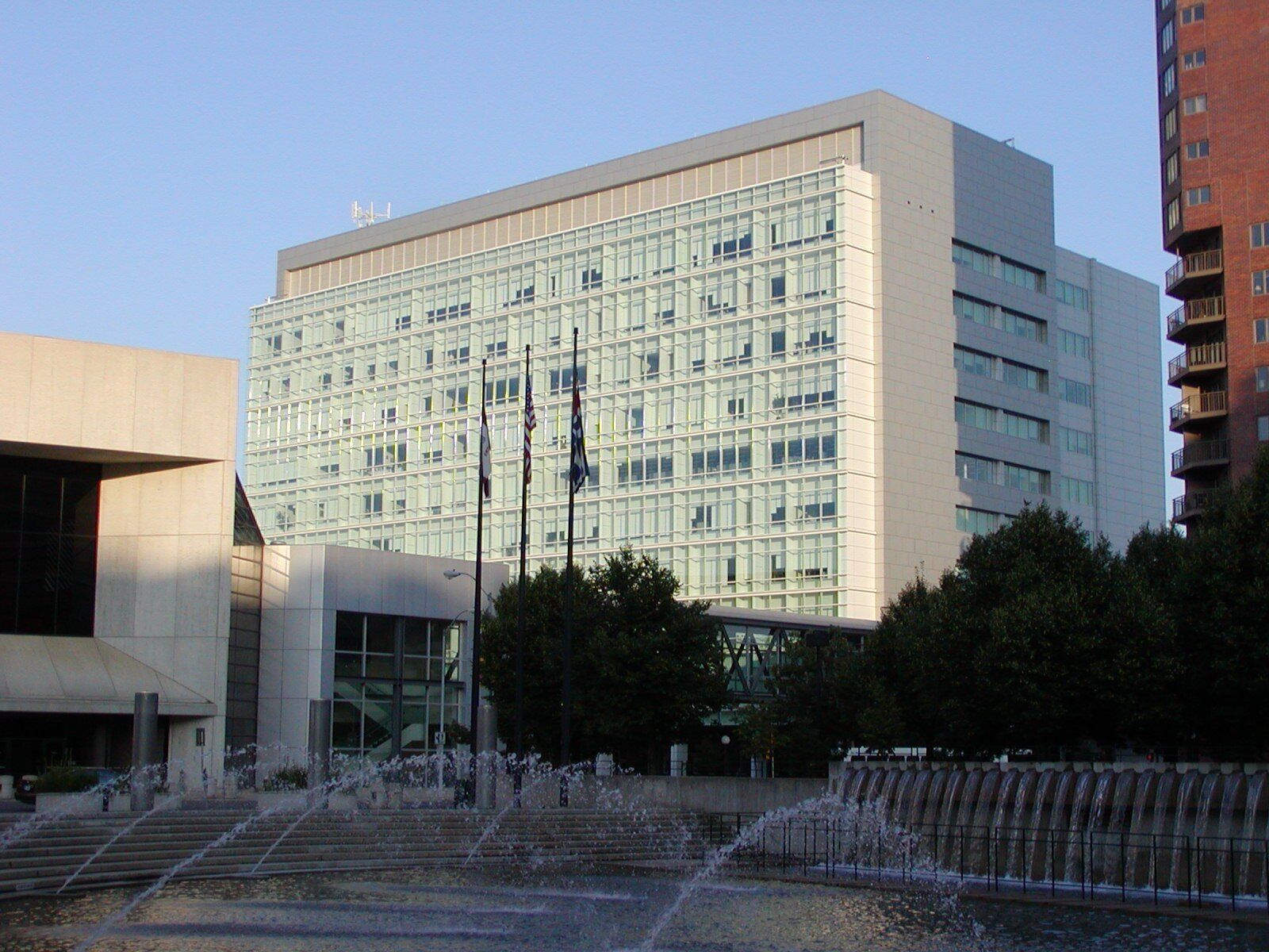 A large building with a fountain in front of it