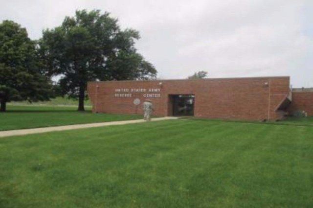 A brick building with a lawn in front of it