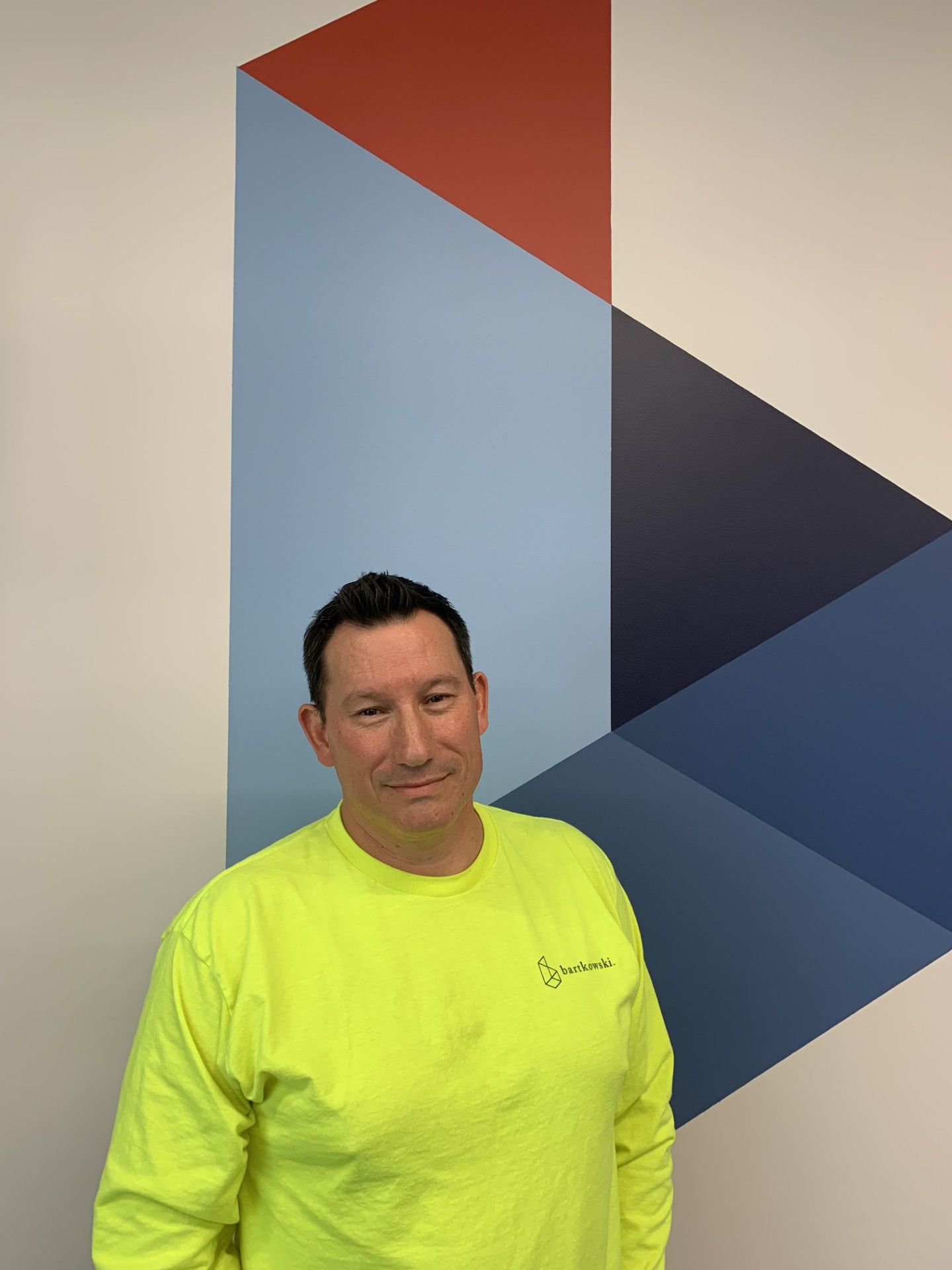 A large building with a lot of windows and trees in front of it