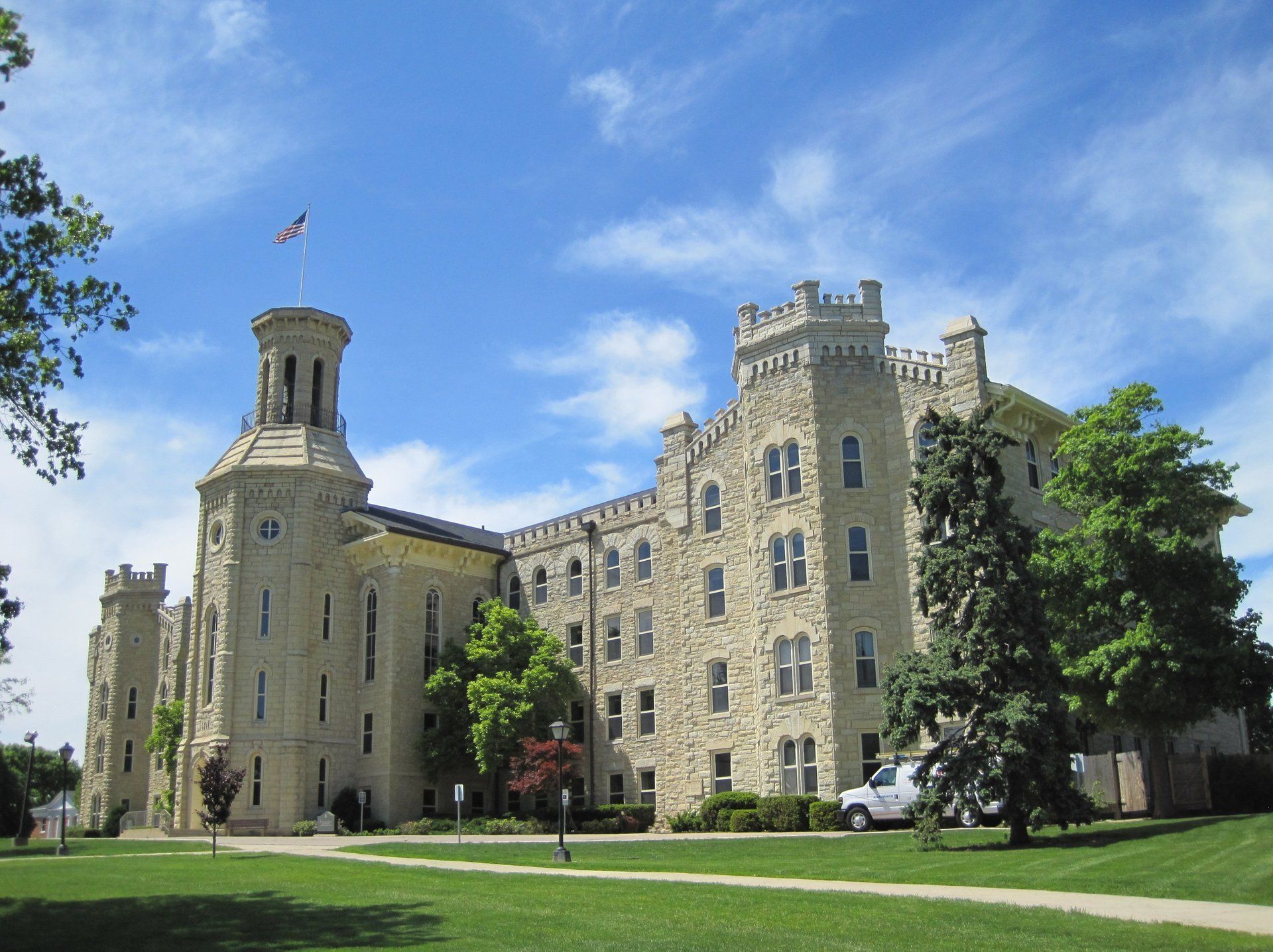 A large stone building with a flag on top of it