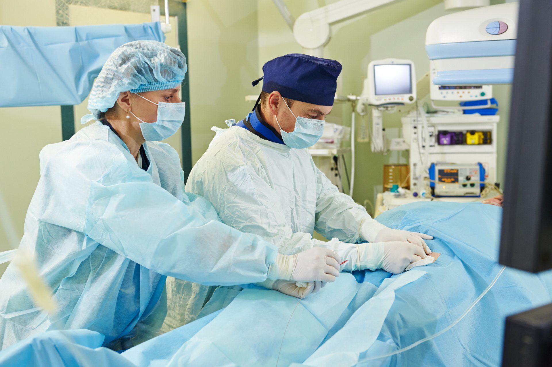 Two surgeons are working on a patient in an operating room.