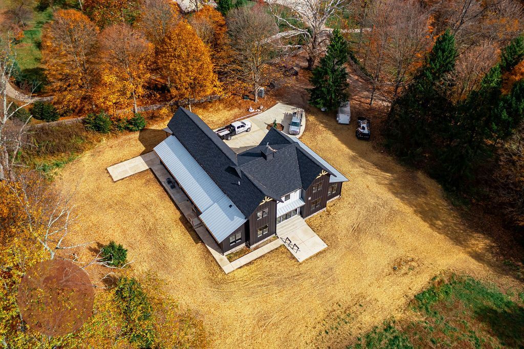 an aerial view of a house in the middle of a field surrounded by trees in Granville, Ohio.