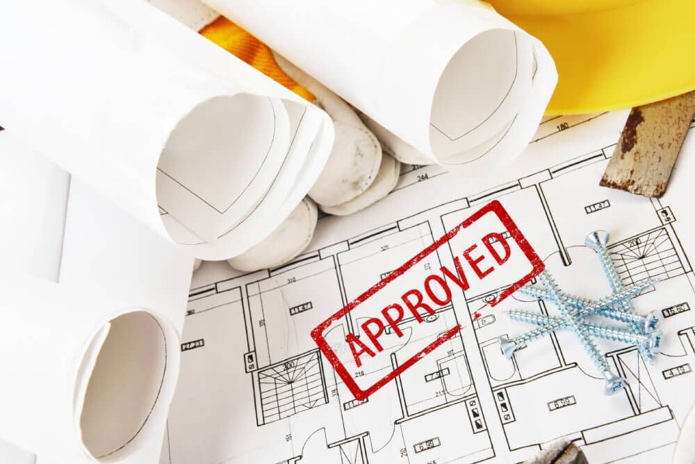 A blueprint with a red stamp that says approved