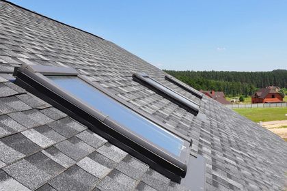 Asphalt Shingles House Roofing Construction with Attic Roof windows, skylights waterproofing.