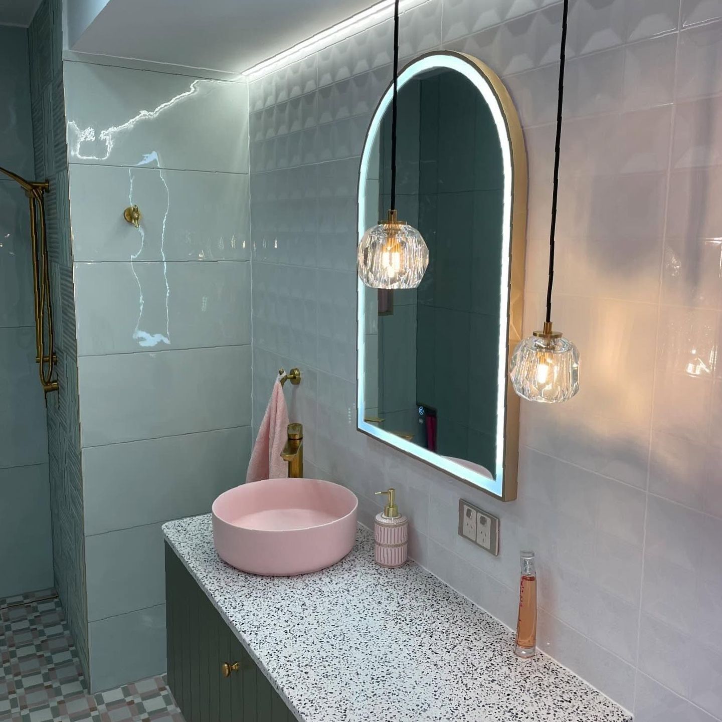 A Bathroom With a Pink Sink and a Mirror — Brightway Lighting in Lismore, NSW