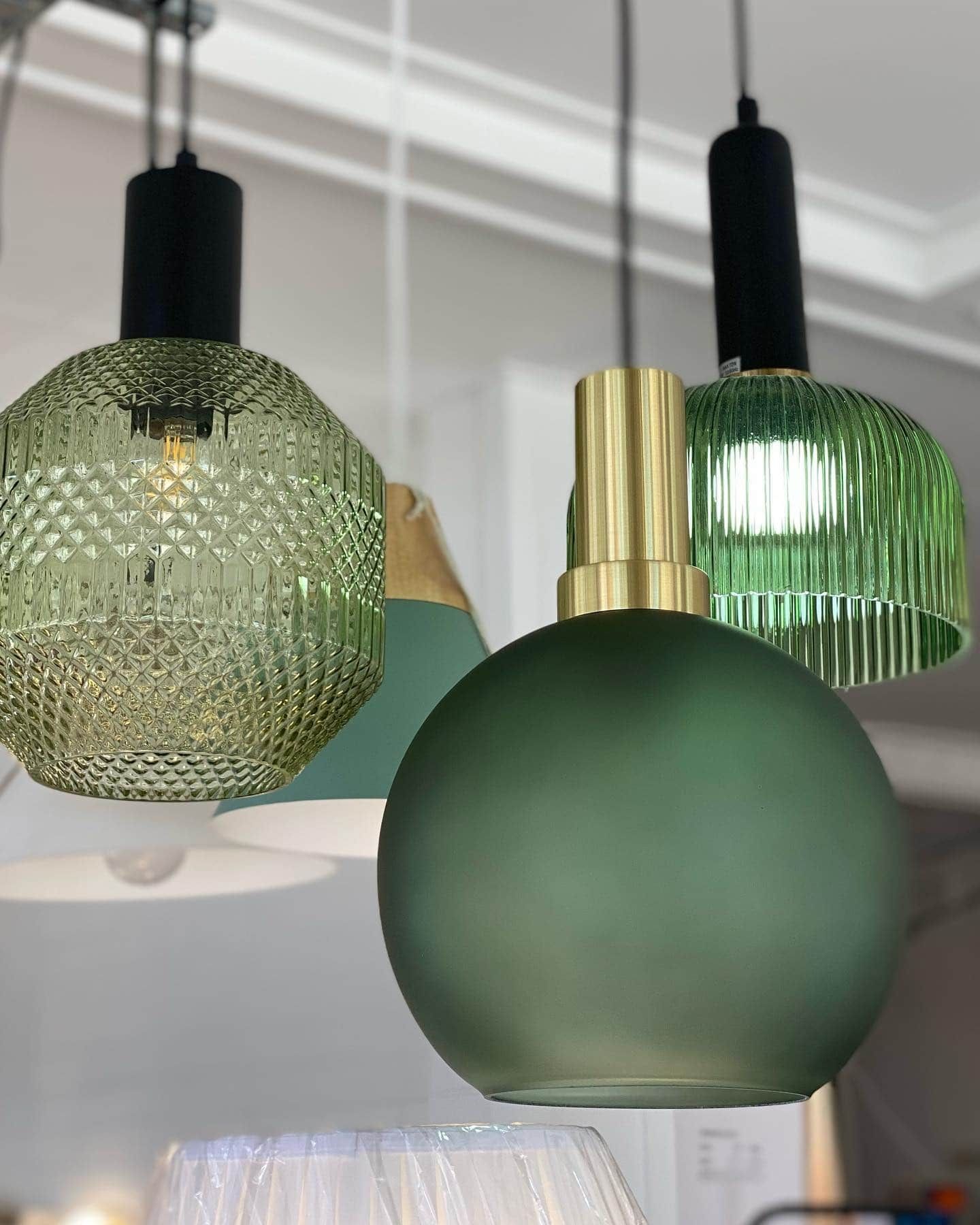 A Stained Glass Lighthouse is Sitting on a Wooden Table — Brightway Lighting in Lismore, NSW