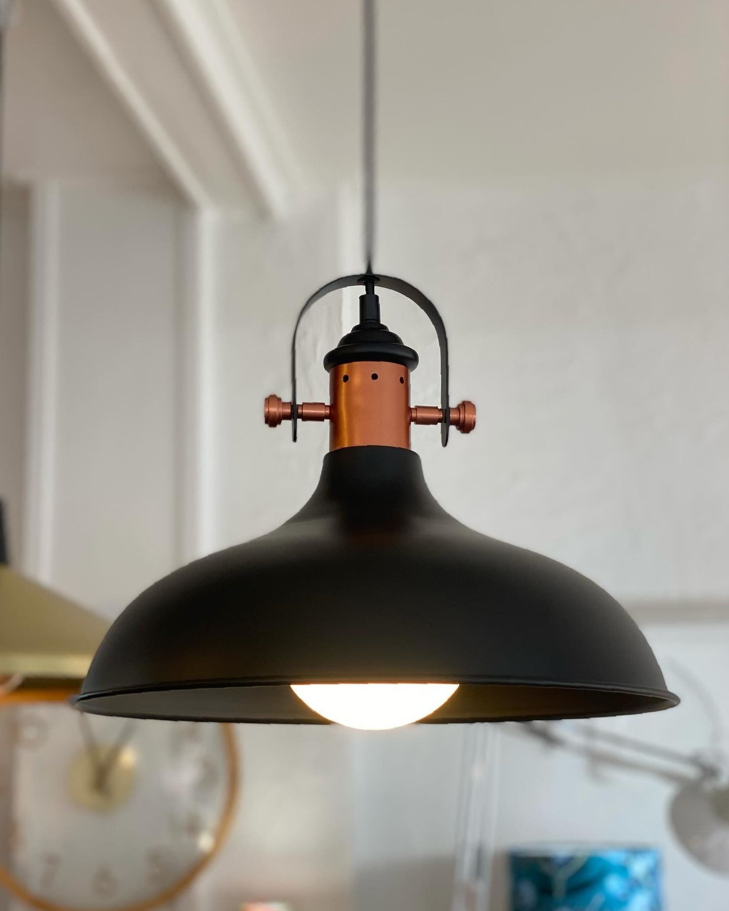 A Black and Gold Lamp With Holes in It — Brightway Lighting in Lismore, NSW