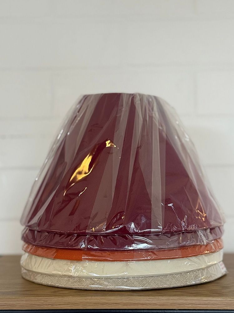 Stack Of Four Maroon, Orange, And Cream Lamp Shades — Brightway Lighting in Lismore, NSW