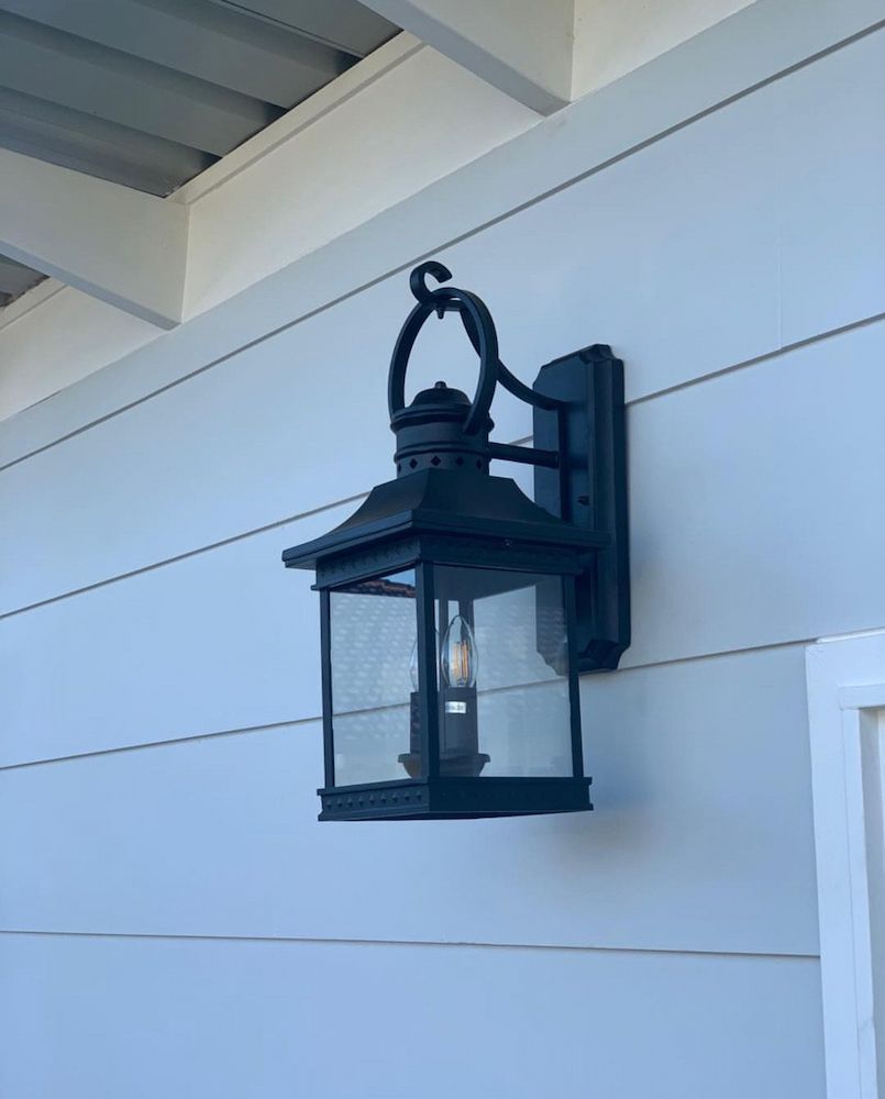 A Black Ceiling Fan is Hanging From the Ceiling — Brightway Lighting in Lismore, NSW