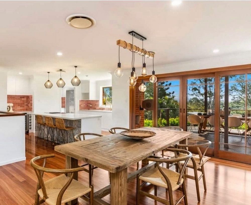 Rustic Dining Room With Wooden Table, Chairs, and Pendant Lights — Brightway Lighting in Lismore, NSW