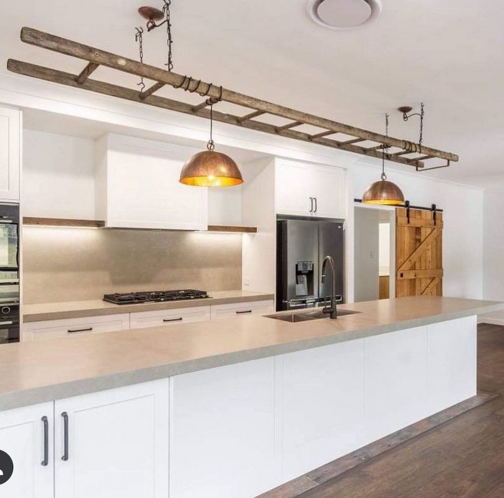 Modern Kitchen With White Cabinets and Copper Pendant Lights — Brightway Lighting in Lismore, NSW