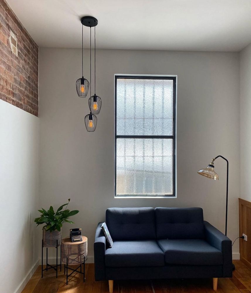 Cozy Room With a Blue Sofa, Window, and Pendant Lights — Brightway Lighting in Lismore, NSW