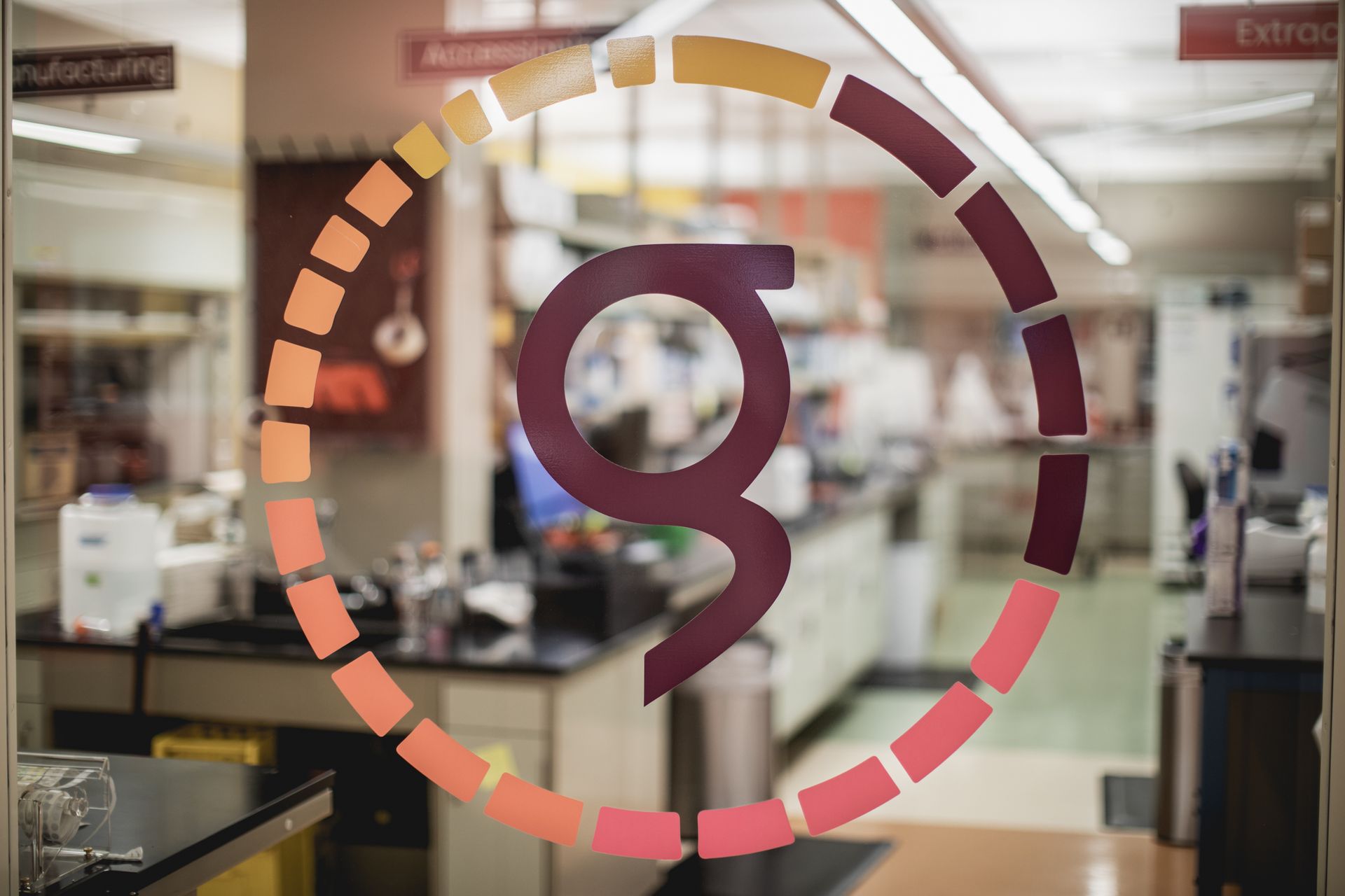 Genomic Prediction logo is on a glass door in a laboratory.