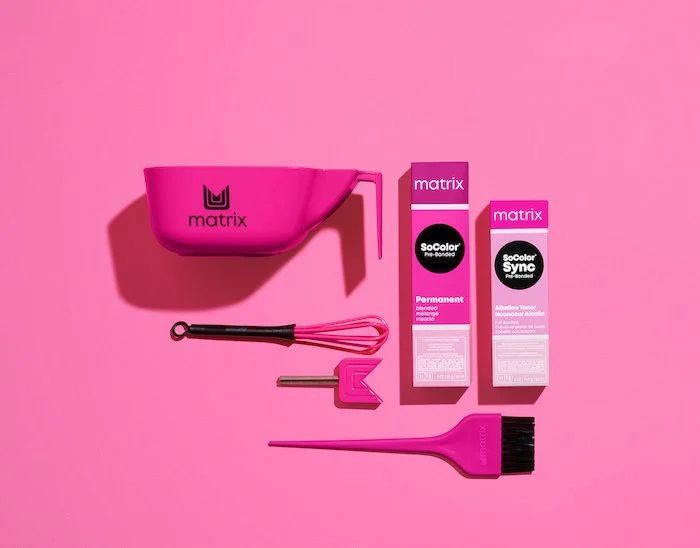 A Pink Hair Dye Kit Is Sitting On A Pink Surface — Genesis Hair and Beauty In Port Kembla, NSW 