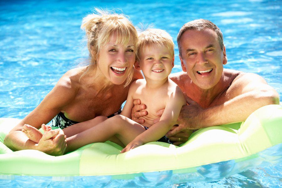 Grandparents And Grandson Having Fun In Swimming Pool — Liverpool, NY — CoolWaters Pool & Spa