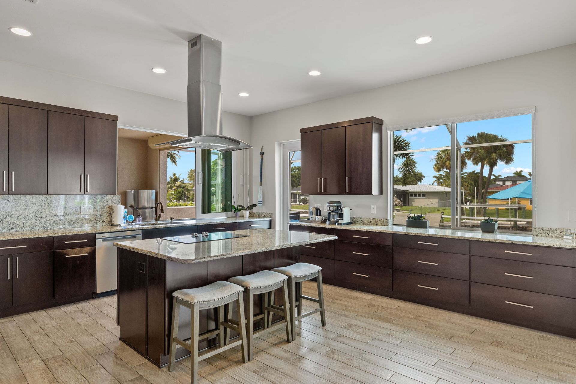 A large kitchen at congo breeze with a large island and stools.