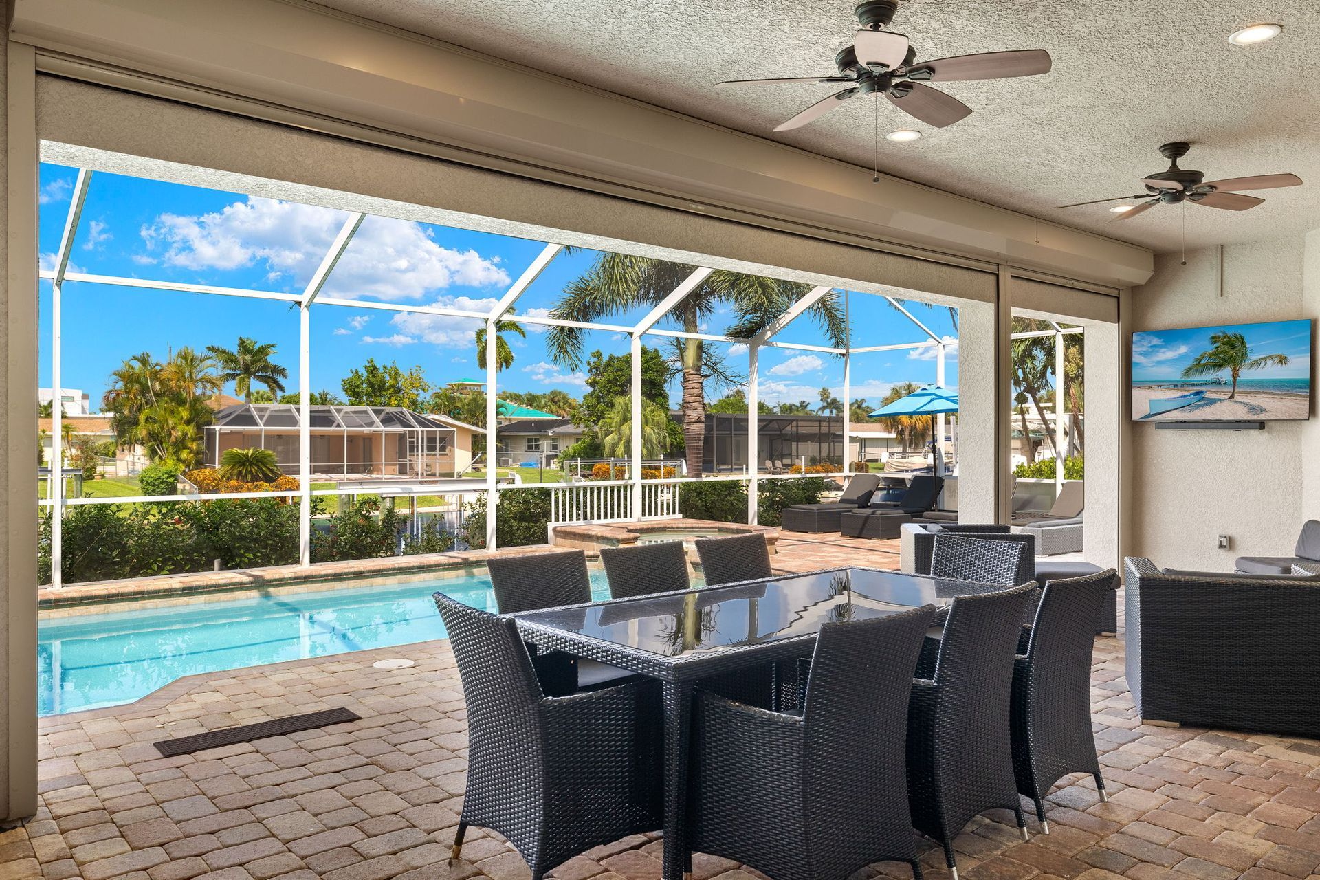 A patio with a table and chairs and a swimming pool