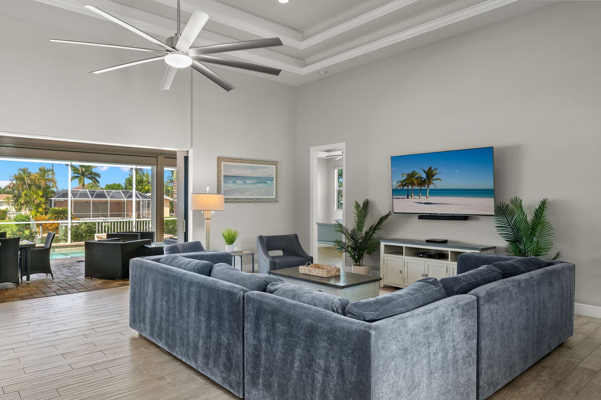 A living room with a large sectional couch and a flat screen tv.
