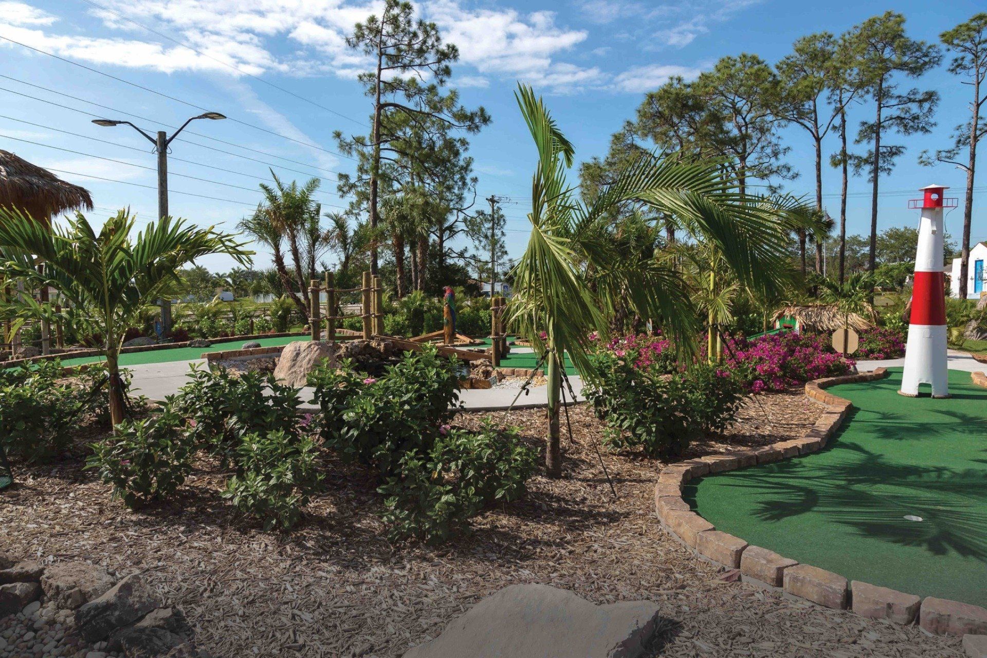 A golf course with a lighthouse in the middle of it