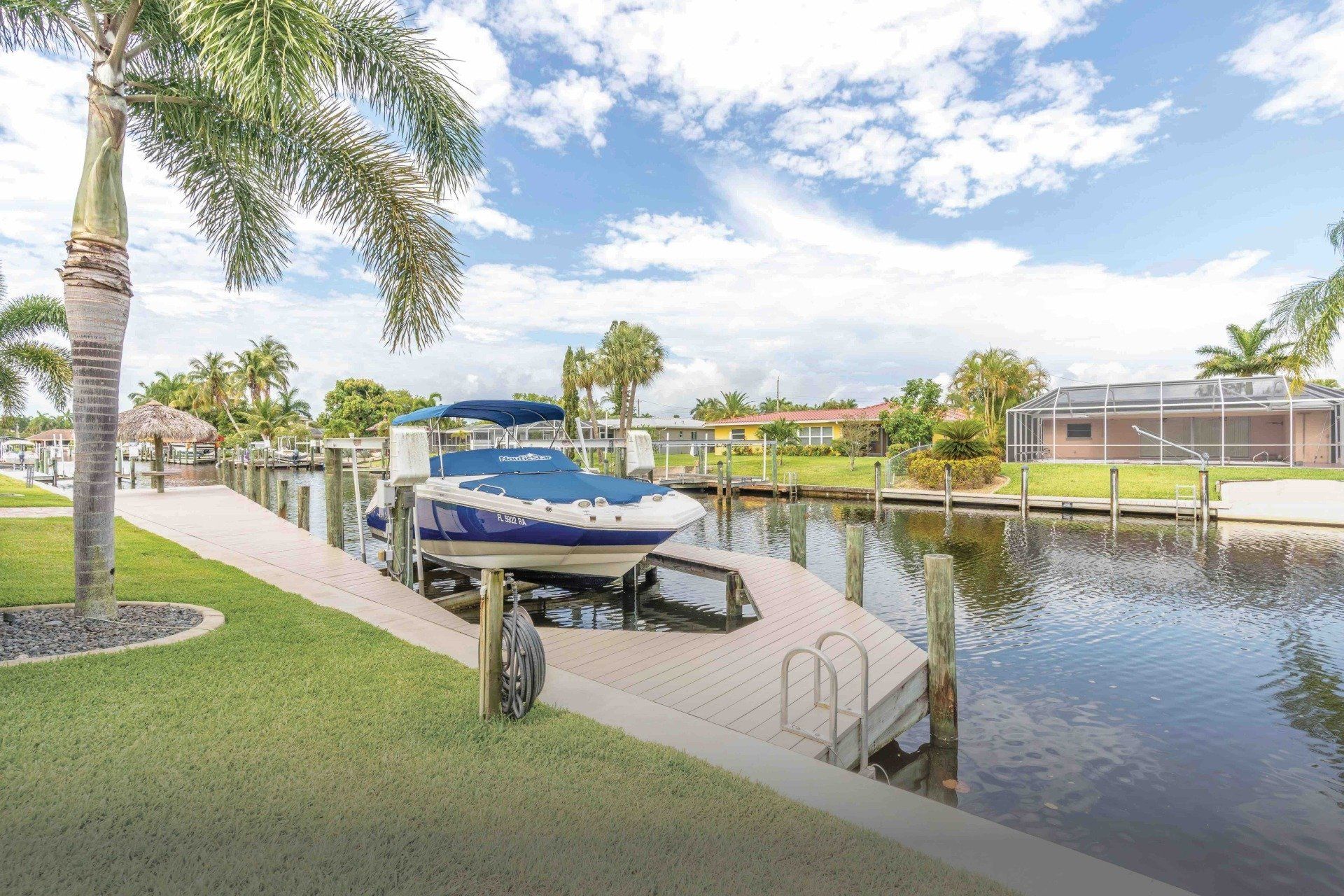 A boat is docked at congo breeze vacation rental in  cape coral florida.